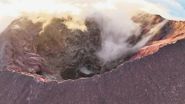 Aerial view of kerinci volcano crater above the clouds with smoke, Sumatra, Indonesia.