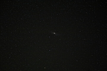 Stars on a clear and black sky with andromeda galaxy in the center