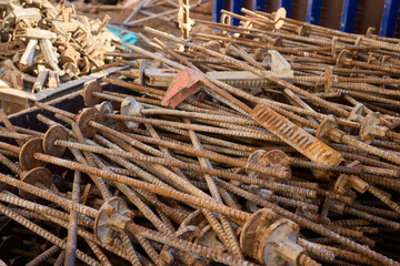 Rusty metal and steel rods discovered on a construction site amidst other equipment and debris