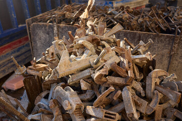 Rusty metal and steel rods discovered on a construction site amidst other equipment and debris