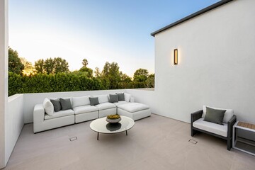 Modern outdoor patio with sunset backdrop