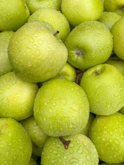 water drops on pile of fresh green apple fruits