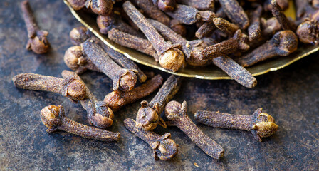 Aromatic thanksgiving or christmas holiday spices, cloves on metal background in the kitchen