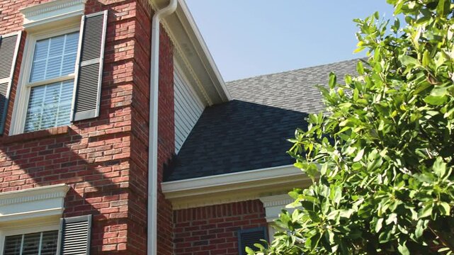 A shot showcasing a new roof with newly installed gutter, fascia, and soffit. Perfect for highlighting roofing and exterior home improvement projects.