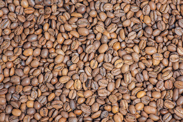 Roasted coffee beans as a background.