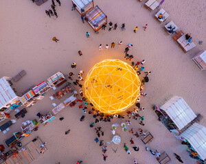 Victoria Island, Nigeria - 02 December 2023: Aerial view of vibrant outdoor market with illuminated light balls and crowd of people, Victoria Island, Nigeria.