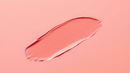 Fototapeta premium a smear of pinkish-coral colored cream or makeup product on a matching background, highlighting the texture and color of the product