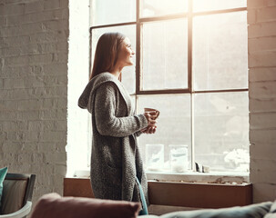 Relax, coffee and woman looking out window from her home, thinking and daydreaming on a quiet...