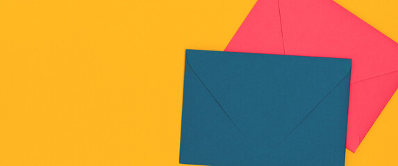Banner with multicolored envelopes on a yellow background with copy space.