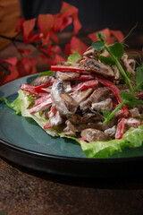 Russian cuisine. Salad with mushrooms, beef and sweet red pepper