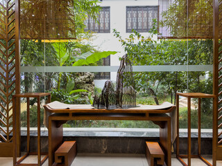 Tranquil Indoor Garden with Elegant Furniture and Artistic Sculpture