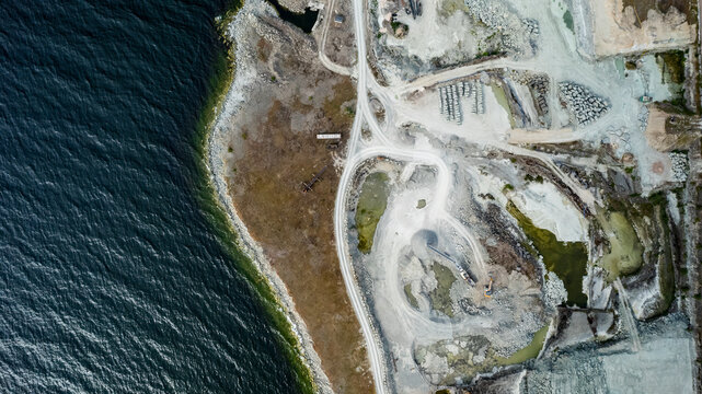 Aerial view of coastal mine with excavator near beautiful beach and sea, Oland Island, Sweden.