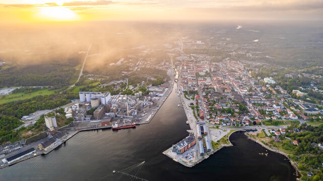 Aerial view of a beautiful sunset over the industrial harbour with boats and a canal, Karlshamn Citadel, Sweden.