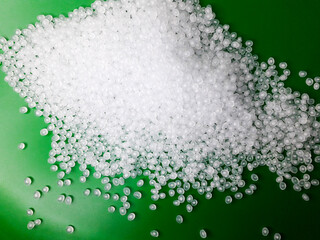 Virgin polypropylene plastic granules on a green background, this polymer is one of the main...