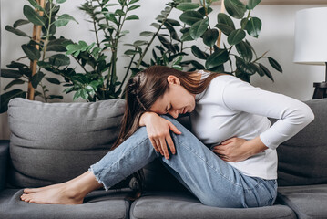 Flatulence young female hand in stomach ache, suffer from food poisoning, abdominal pain and colon...