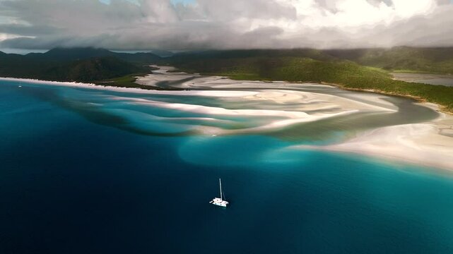 Aerial view of beautiful Whitehaven Beach with yachts and a sandbank in the azure ocean, Whitsundays, Australia.