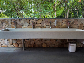 Contemporary Outdoor Sink Area Surrounded by Natural Stone Wall