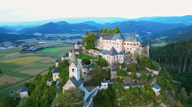 Aerial view of Hochosterwitz castle and fortress surrounded by picturesque mountains and greenery, St. Veit, Austria.