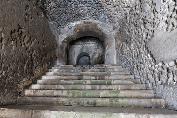 Wander through the ancient stone pathways of the Arles Roman Era Amphitheater, where cave-like passages and carved steps create a mystical journey. Each step echoes with history, inviting exploration
