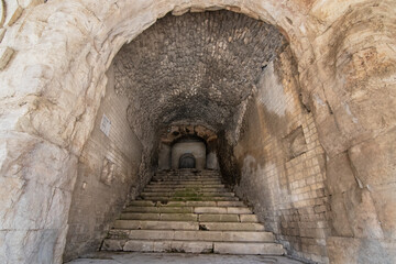 Wander through the ancient stone pathways of the Arles Roman Era Amphitheater, where cave-like passages and carved steps create a mystical journey. Each step echoes with history, inviting exploration
