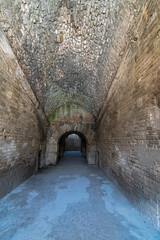 Wander through the ancient stone pathways of the Arles Roman Era Amphitheater, where cave-like passages and carved steps create a mystical journey. Each step echoes with history, inviting exploration
