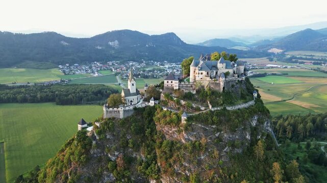 Aerial view of hochosterwitz castle on a hilltop surrounded by scenic mountains and greenery, St. Veit, Austria.