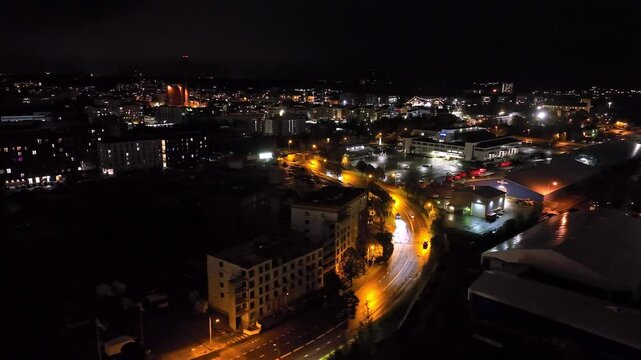 Aerial view around traffic on the illuminated streets of Turku, night in Finland