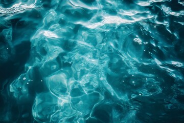 Fototapeta premium Sunlight reflecting on a crystal clear turquoise water surface background for aqua sea, ocean design concept