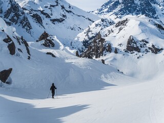 Person snowshoeing in snowy mountain landscape