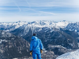 Skier overlooking Serre Chevalier mountains