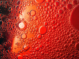 Abstract Background Red oil Macro Colorful artistic of oil drop floating on the water. macro red bubble oil of wallpeper, blood concept