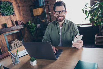 Photo of positive good mood specialist dressed shirt working modern gadgets indoors workstation...