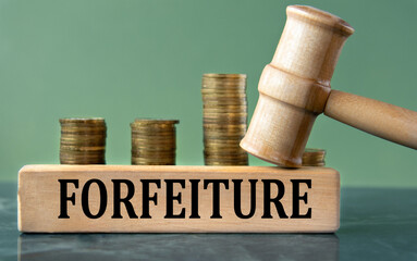 FORFEITURE - word on a white sheet with a judge's gavel and a stack of coins in the background