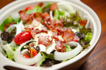 Salad with bacon and cheese and Caesar dressing