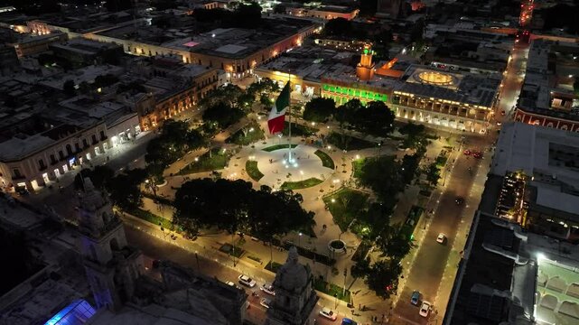 Aerial view of illuminated merida plaza bustling with vibrant nightlife and colorful buildings, merida, mexico.