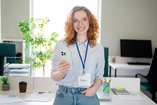 Photo of lovely young lady working trainee hold device dressed formalwear business manager comfortable startup office room interior