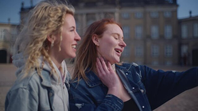 Two Women Taking A Selfie With Amalienborg Palace In The Background