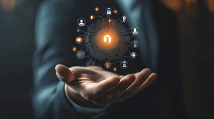 A businessman’s hand holding a biometric security icon alongside technological symbols, emphasizing authentication, identity verification, and secure access control.



