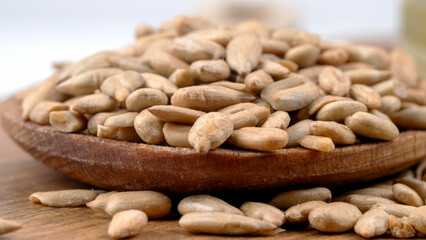 peeled sunflower seeds on a wooden background