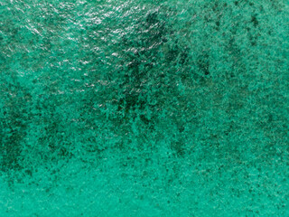Aerial view of a serene turquoise ocean surface.