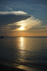 A serene sunset over a calm ocean horizon.