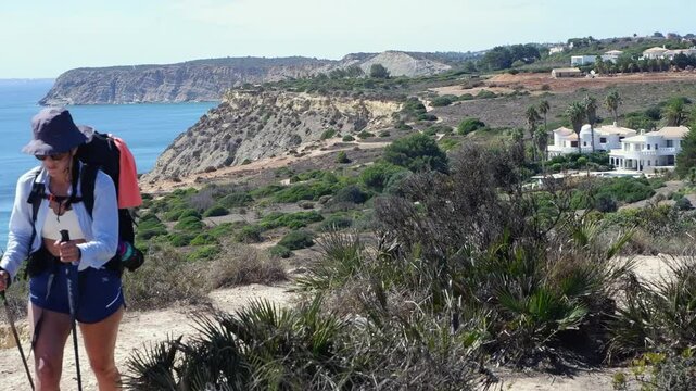 Female backpacker with hiking poles trekking on Fisherman's Trail PRT