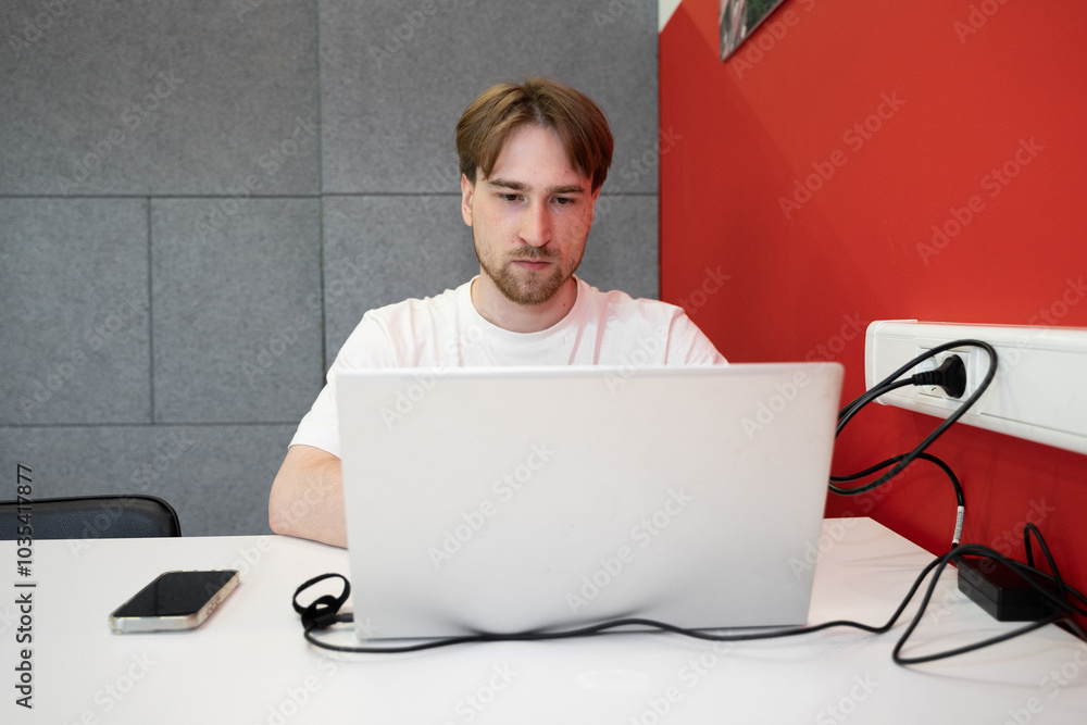 Aufkleber a focused it specialist works diligently on a laptop in a coworking space, immersed in programming t