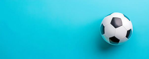 Soccer ball on bright blue background with copy space