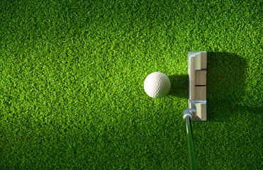Top view of golf ball and putter on green grass. © Paitoon