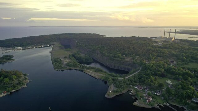 Aerial view of sunset over the industrial harbour with boats and pier, Karlshamn Citadel, Sweden.