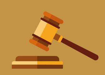 A wooden hammer with a wooden handle is on top of a wooden base. The hammer is being used to symbolize the power of the law