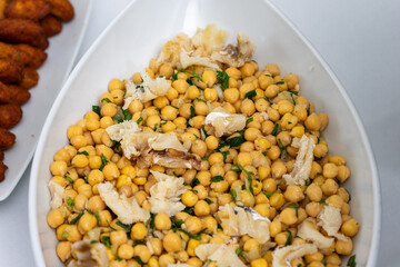 Traditional Portuguese dish featuring chickpeas with cod served at a hotel buffet, showcasing vibrant colors and authentic flavors