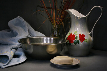Still life with a jug, towel, soap and basin with water for washing