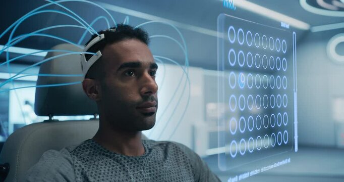 Man Uses a Neural Headset in a Futuristic Lab, Interacting With a Holographic Interface Displaying a Grid of Circles, Man Playing Video Game with His Mind Manipulating Figures.